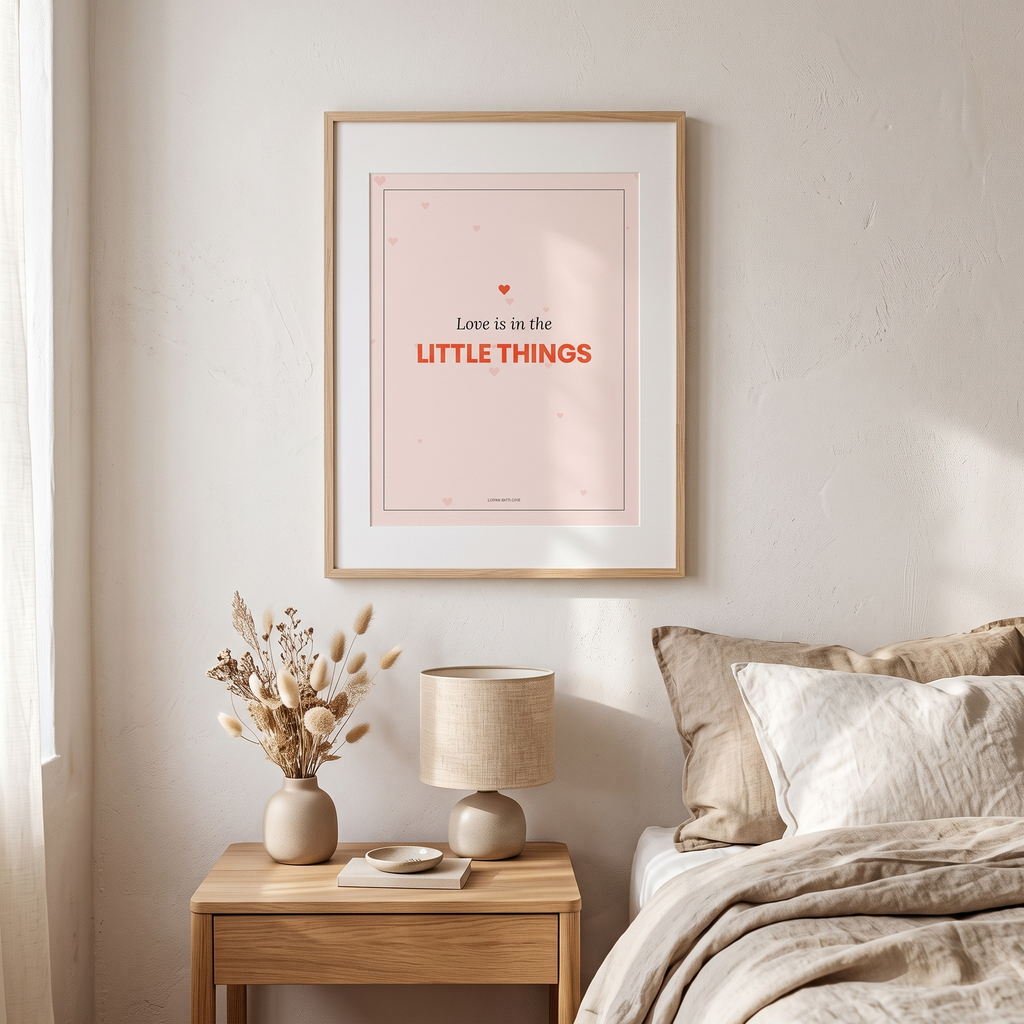 Love is in the little things print framed above a bedside table
