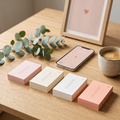 Four stacks of printed love notes with a framed print and a phone wallpaper
